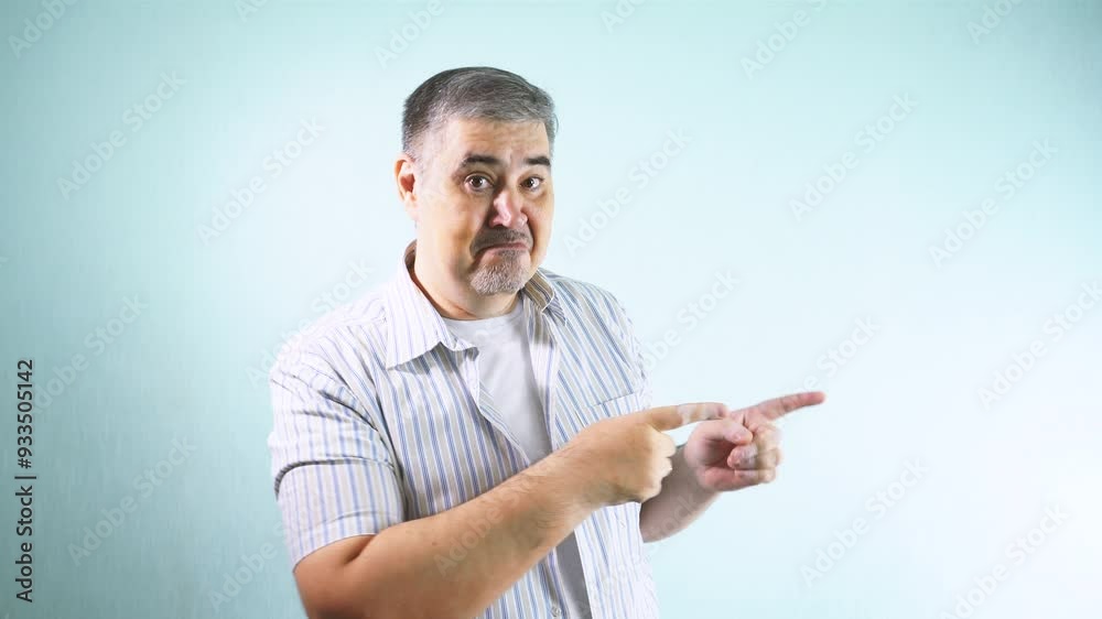 A man smiling at the camera and pointing towards something off-screen. Perfect for advertising and promotional content. A man smiling at the camera and pointing towards something off-screen. Perfect for advertising and promotional content.