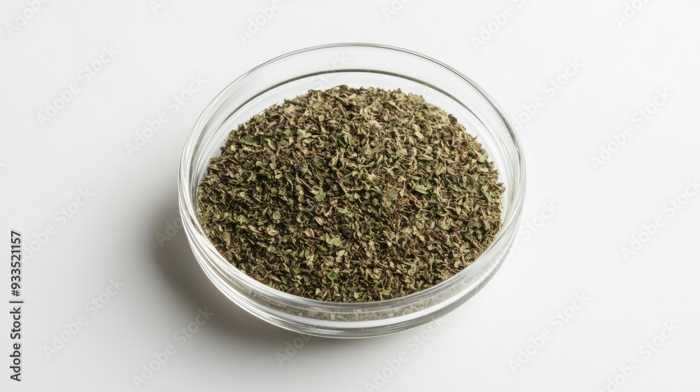 A round glass bowl filled with dried oregano, isolated on a clean white surface, with the herb's details clearly visible through the transparent bowl. A round glass bowl filled with dried oregano, isolated on a clean white surface, with the herb's details clearly visible through the transparent bowl.