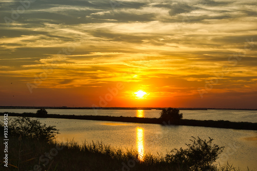 Wide angle view of a summer sunset on the water