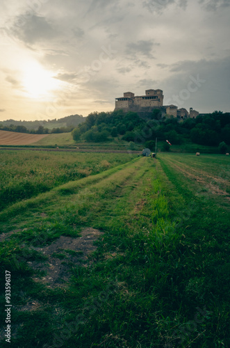 Torrechiara Castle in Parma. On the green hills. Italian hills with ears of wheat.