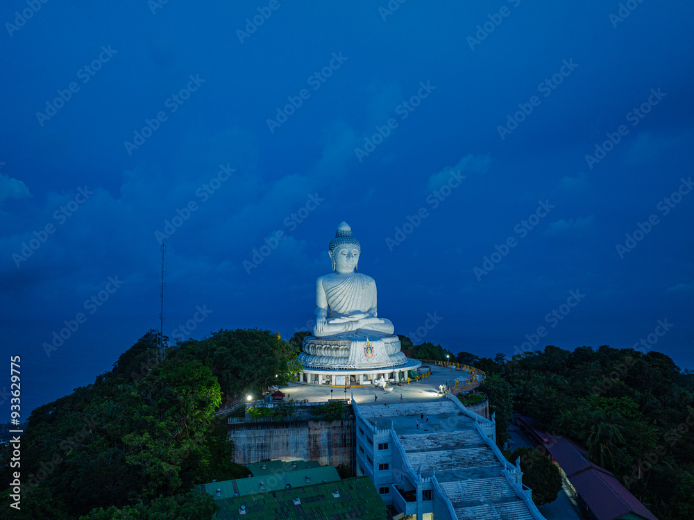 A majestic aerial view of scenery Phuket big Buddha in blue sky The Buddha overlooks the beautiful lush green hills. white clouds and deep blue ocean create a stunning backdrop for the statue. A majestic aerial view of scenery Phuket big Buddha in blue sky The Buddha overlooks the beautiful lush green hills. white clouds and deep blue ocean create a stunning backdrop for the statue.