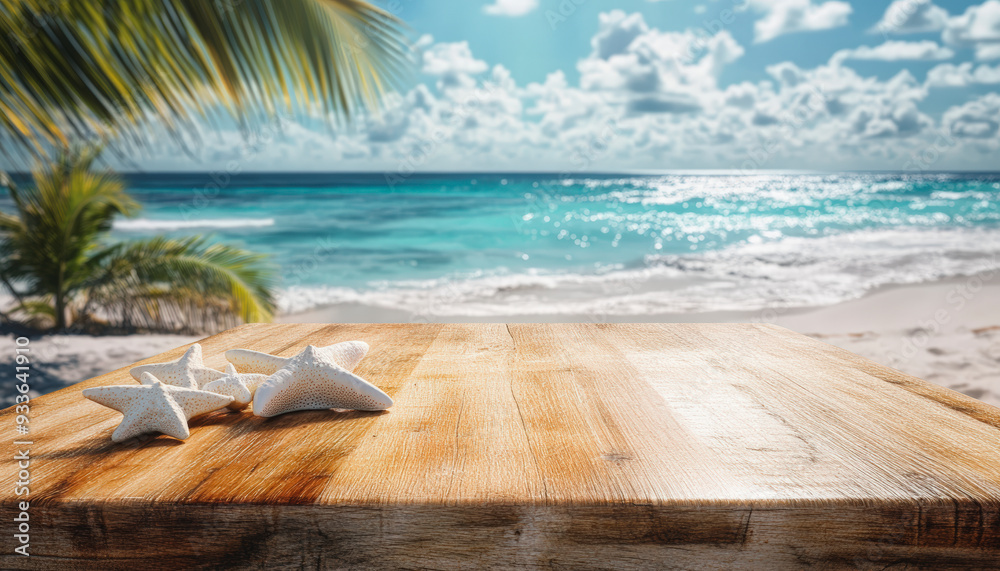 Fototapeta premium A tranquil beach scene with a wooden table in the foreground and white starfish scattered on it, against a backdrop of turquoise ocean waves.