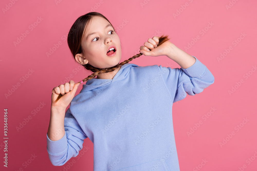 Photo of lovely small schoolkid choke braids wear hoodie isolated on pink color background Photo of lovely small schoolkid choke braids wear hoodie isolated on pink color background