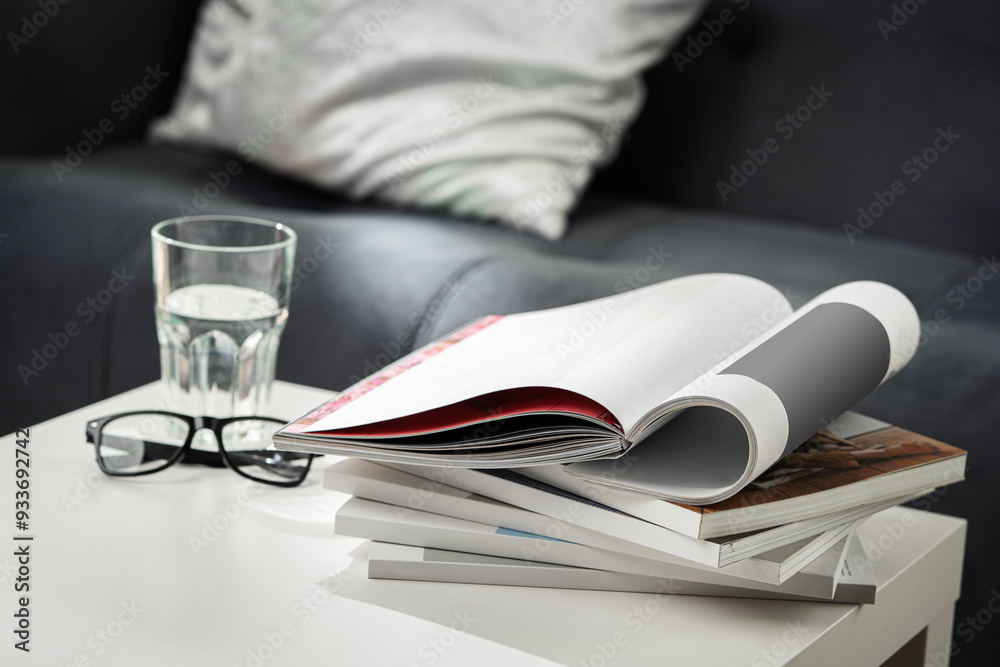 Eyeglasses with stack of books, and the glass of water on the table Eyeglasses with stack of books, and the glass of water on the table