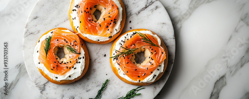 Bagels with cream cheese and smoked salmon on marble surface