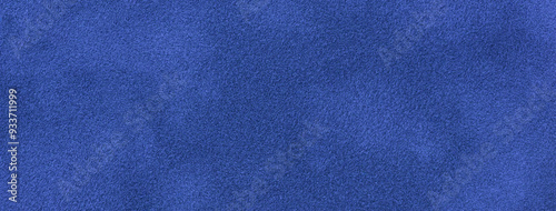 Navy blue matte background of suede fabric, closeup. Velvet texture of seamless sapphire textile, macro.