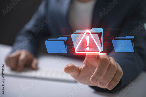 Cybersecurity alert with digital file folder. hand interacting with a cybersecurity alert symbol. malicious software, virus, spyware, malware, or cyberattacks on computer networks.