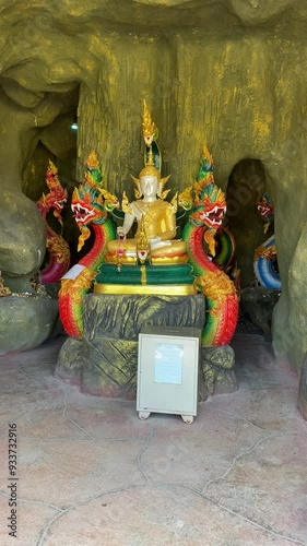 Atmosphere inside Wat Mai Supradittharam,Anonymous people worship or pray to the large Siwali statue and beautiful architecture. photo