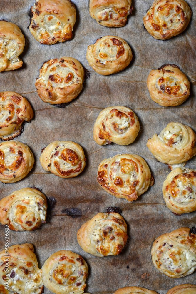 Fototapeta premium Puff pastry rolls on a baking sheet
