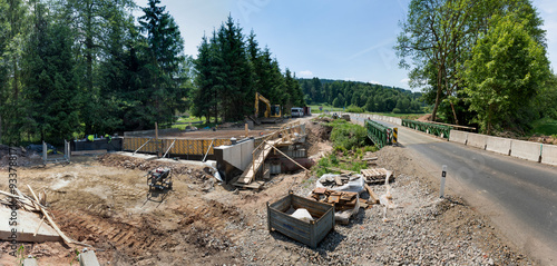 A new bridge across a small river. Summer time. Small reinforced concrete bridge after reconstruction. New asphalt.
Infrastructure construction at the final stage of. Small Reinforced Concrete Bridge 