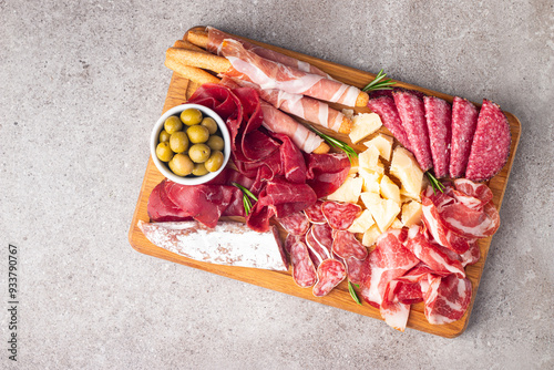 Charcuterie board. Antipasti appetizers of meat and cheese platter with salami, prosciutto crudo or jamon and olives