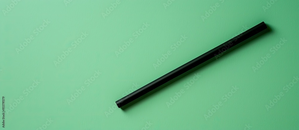 Green background with a space for a copy space image featuring a single rod snack tube. Green background with a space for a copy space image featuring a single rod snack tube.