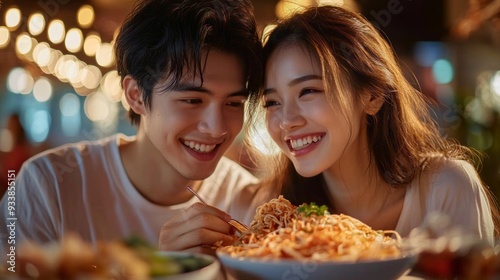 Laughter fills the air as two lovers enjoy a delightful meal together, creating a memorable moment under the soft glow of restaurant lights