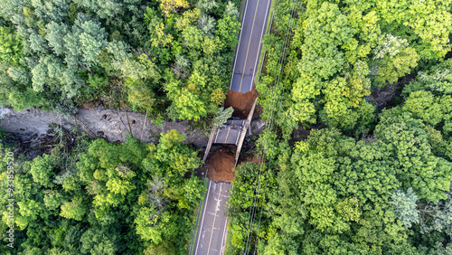 Aerial view of river, road and bridge destroyed by the heavy rain and flood