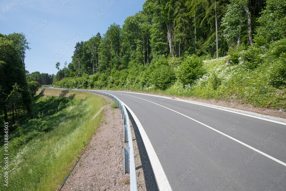 Fototapeta premium Road with asphalt coating. Heavy and light vehicle movement a road among the mountains. Paved road for car traffic, construction of a new paved road for transport in rural areas