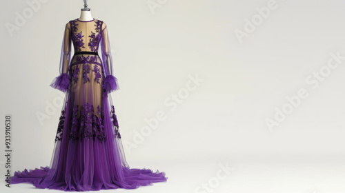 A stunning purple evening gown with lace details showcased on an empty mannequin