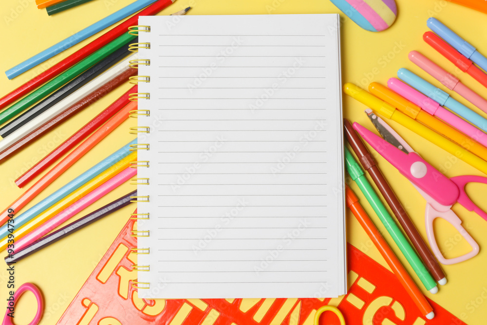 Back to school concept with variety of office and school supplies on yellow background. Back to school concept with variety of office and school supplies on yellow background.