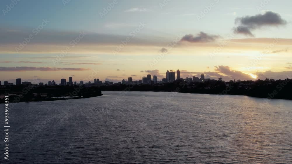 A beautiful sunset casts vibrant hues over the city skyline as the river reflects the colors, creating a tranquil and picturesque atmosphere. A beautiful sunset casts vibrant hues over the city skyline as the river reflects the colors, creating a tranquil and picturesque atmosphere.