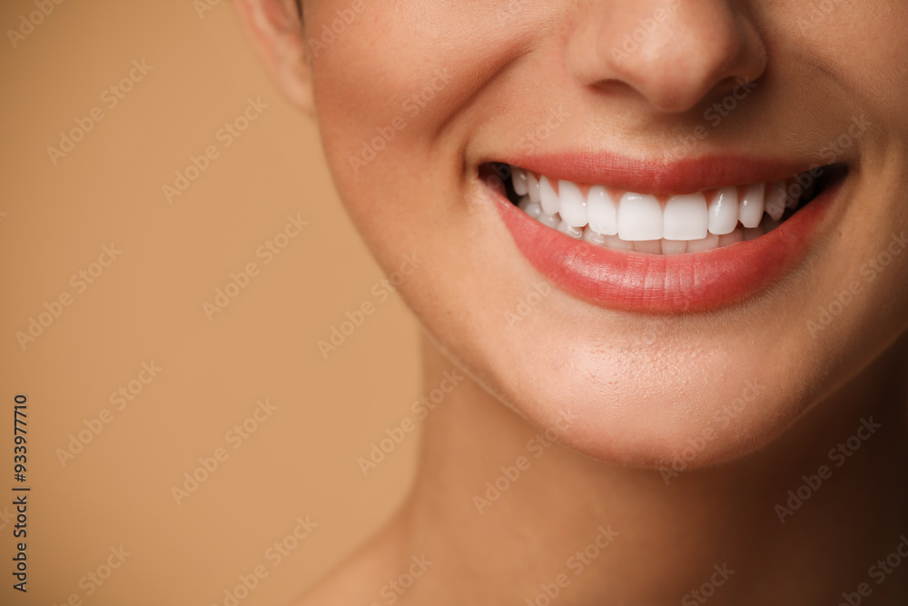 Fototapeta premium Smiling woman on beige background, closeup. Dental veneers