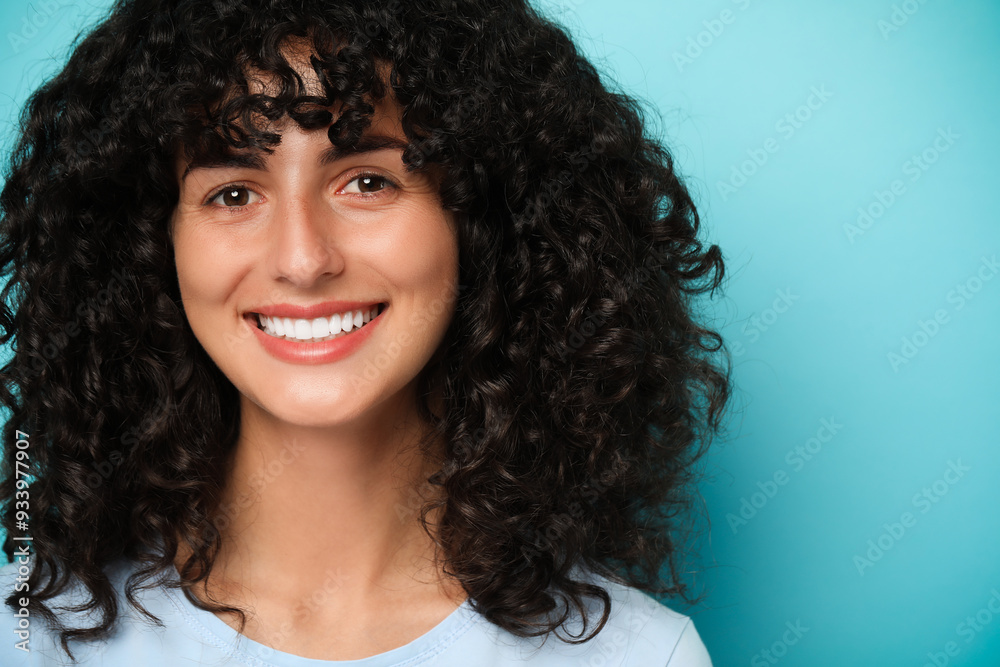 Happy young woman on light blue background. Dental veneers Happy young woman on light blue background. Dental veneers