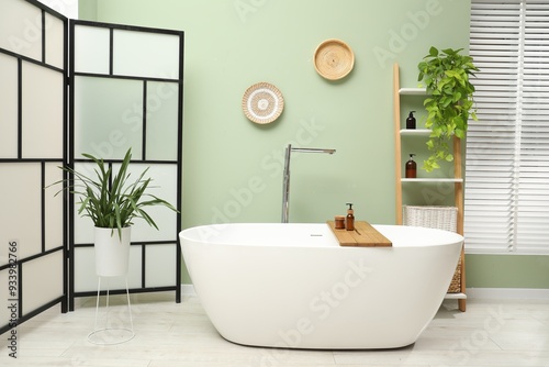 Stylish bathroom interior with folding screen and tub