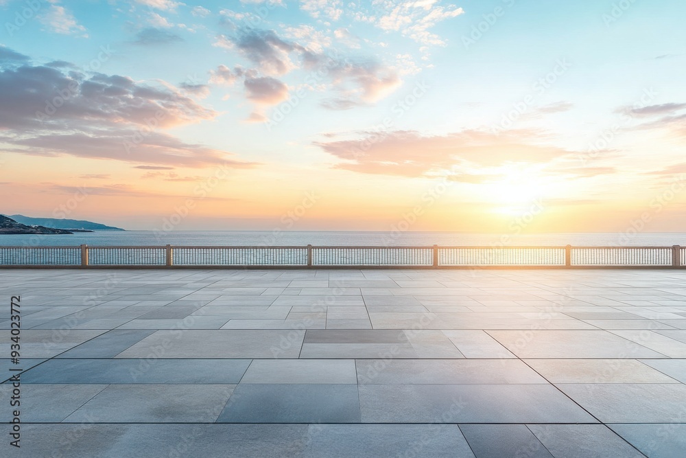 A serene coastal sunset over the ocean with a paved foreground. A serene coastal sunset over the ocean with a paved foreground.