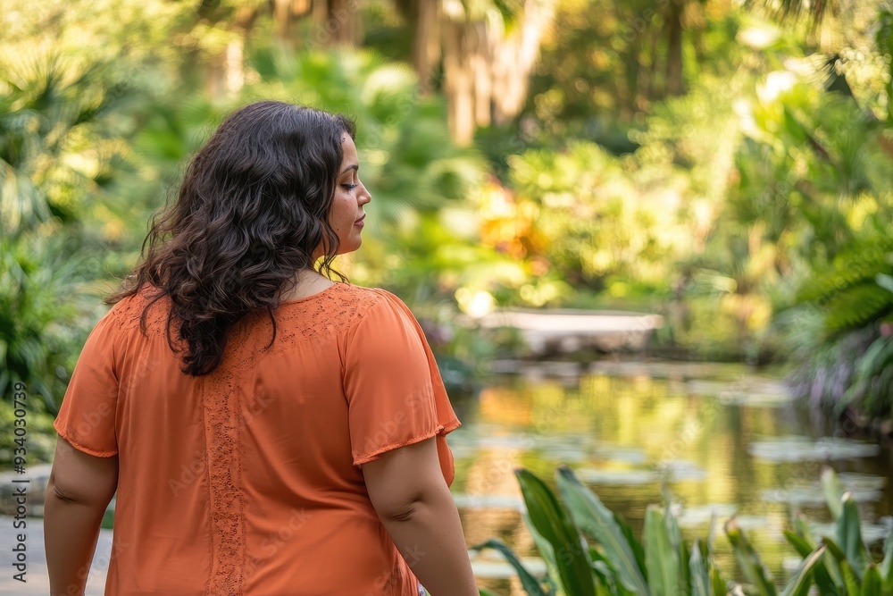 Profile view of a Latina woman with vitiligo practicing mindful walking, capturing the balance of movement and reflection (selective focus, theme: walking meditation) in a botanical garden Profile view of a Latina woman with vitiligo practicing mindful walking, capturing the balance of movement and reflection (selective focus, theme: walking meditation) in a botanical garden