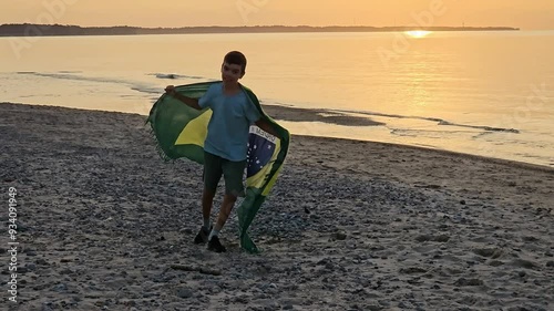 boy running on sand with brazilian flag, brazilian flag, christmas in southern hemisphere, new year on travel, vacation on sand, holidays on beach, childhood, vacation, santa hat, mother, son, brazili photo