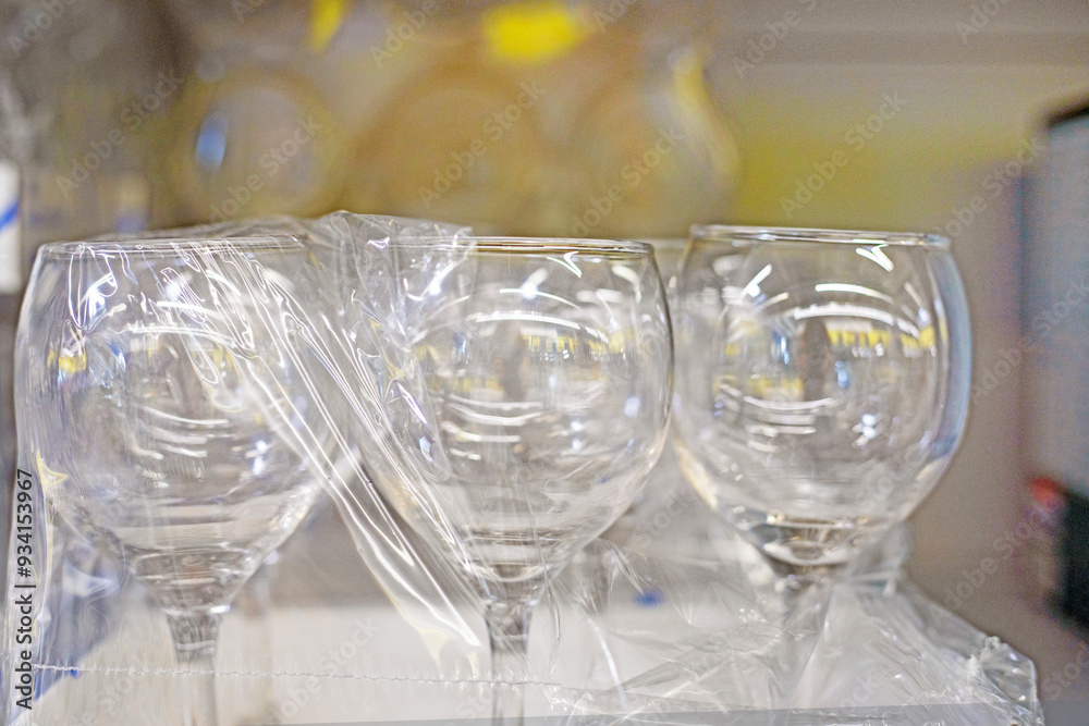 packed glass cups on the shelf in the supermarket. Stylish glasses packed glass cups on the shelf in the supermarket. Stylish glasses