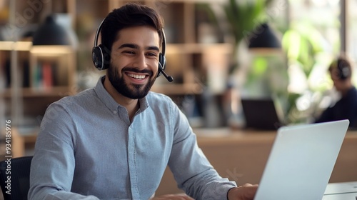 Happy Indian call center agent wearing headset talking to client working in customer support office. Professional contract service telemarketing operator using laptop having conversation.	
