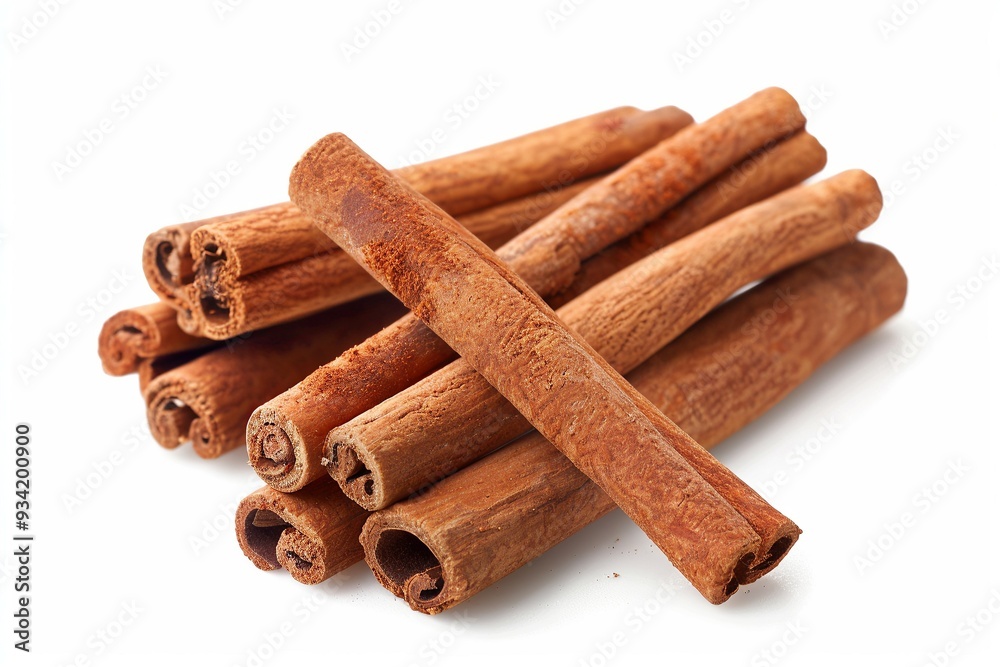 Sticks of cinnamon arranged on a white surface
