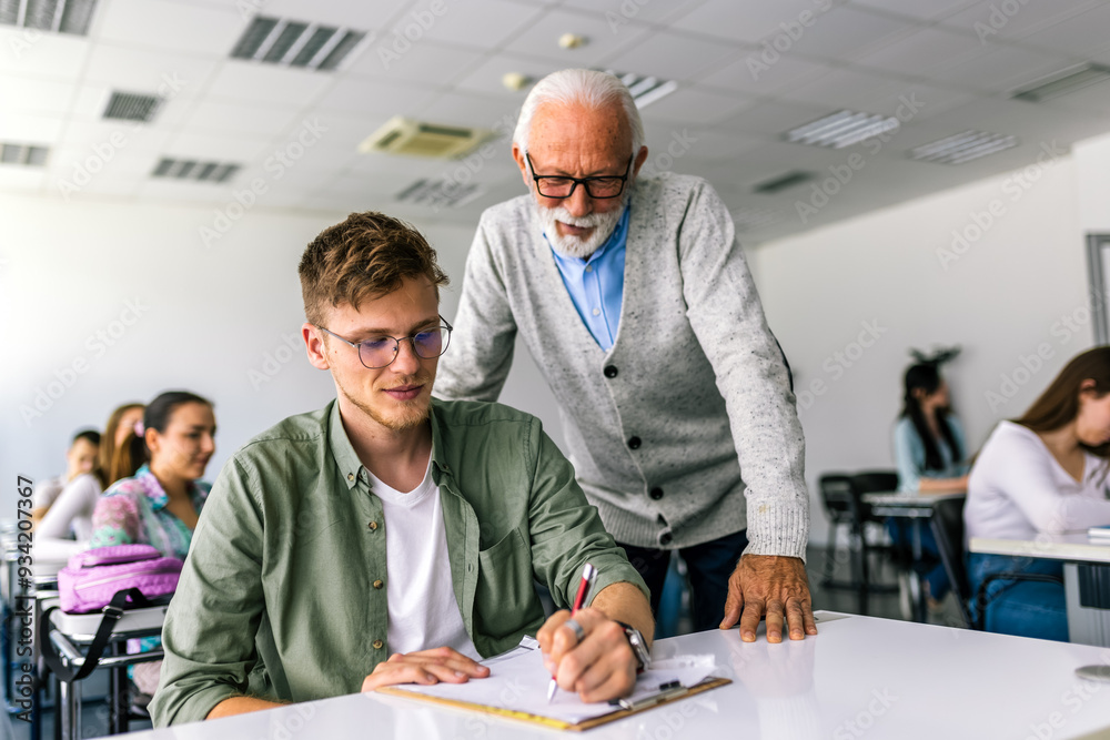 Senior teacher explaining a lesson to one of his students. Senior teacher explaining a lesson to one of his students.