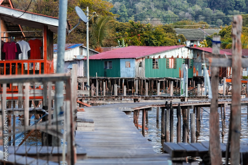 Fishing village houses over the water garbage poor areas in Sabah province in Malaysia photo