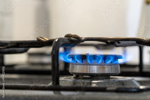 A moka pot on a gas stove, brewing coffee traditionally over an intense blue flame, with controlled heat from the gas stove. Gas ignition and various stages of the flame burning. 