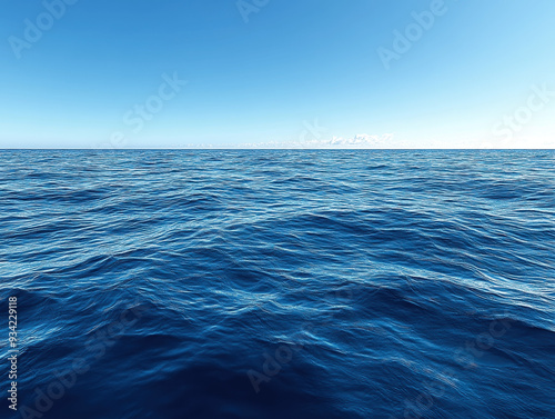 A serene view of the calm ocean on a sunny day under clear blue skies, showcasing the endless horizon and gentle waves reflecting sunlight photo