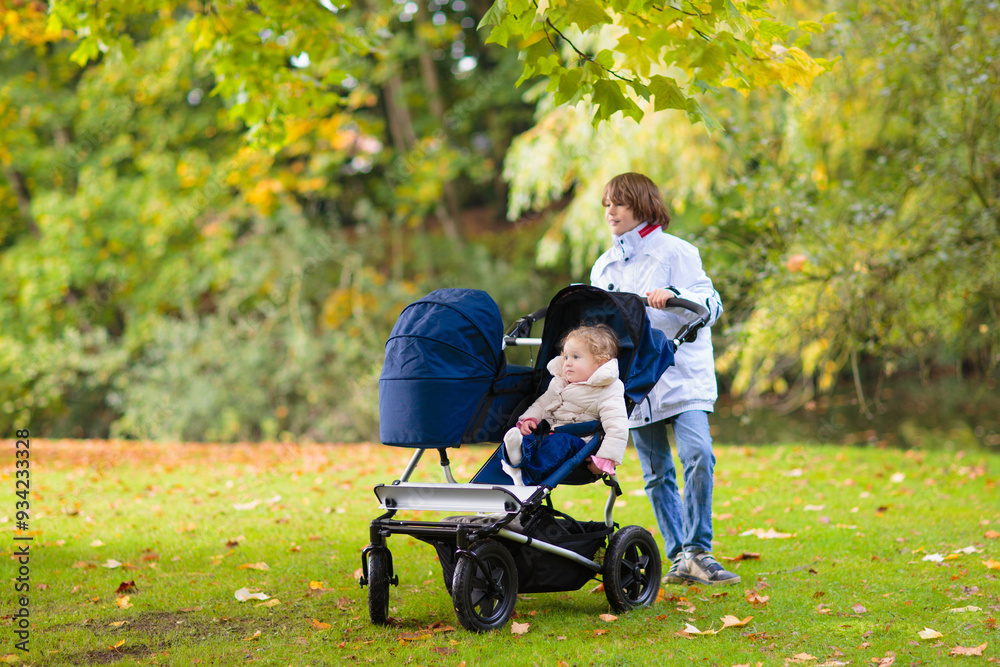 Child in fall park. Kid with autumn leaves. Child in fall park. Kid with autumn leaves.