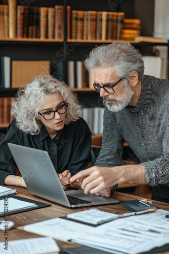  Entrepreneur strategizing with a mentor in a quiet office – A close-up of an intense discussion between a young entrepreneur and an experienced mentor in a quiet, elegant office