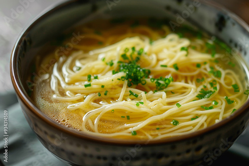 A bowl of noodles with green herbs on top