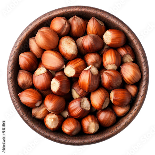 Top view roasted hazelnuts in a dark wooden bowl isolated on transparent background 