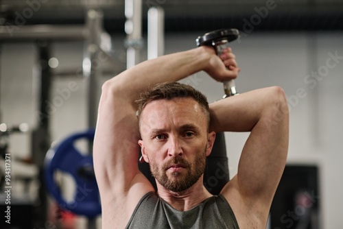 Caucasian man focused on camera while doing exercise