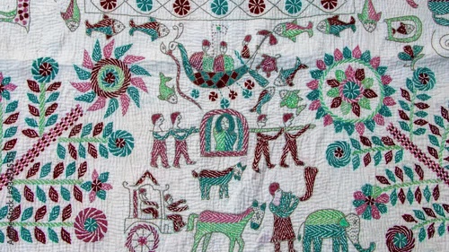 Artistry of intricate hand-sewn Nakshi Kantha, a timeless Bangladeshi textile tradition blending colorful designs and cultural heritage through exquisite stitching	 photo