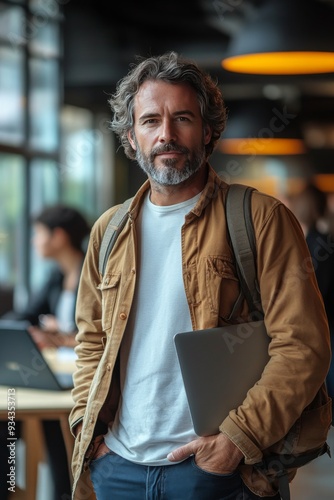 Professional man with laptop in a modern workspace during the afternoon