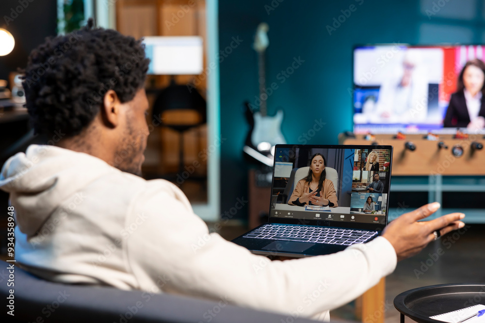 Remote employee talks with board of directors during videocall business meeting from home office. Teleworker speaks in remote teleconference telework call, receiving feedback from management Remote employee talks with board of directors during videocall business meeting from home office. Teleworker speaks in remote teleconference telework call, receiving feedback from management