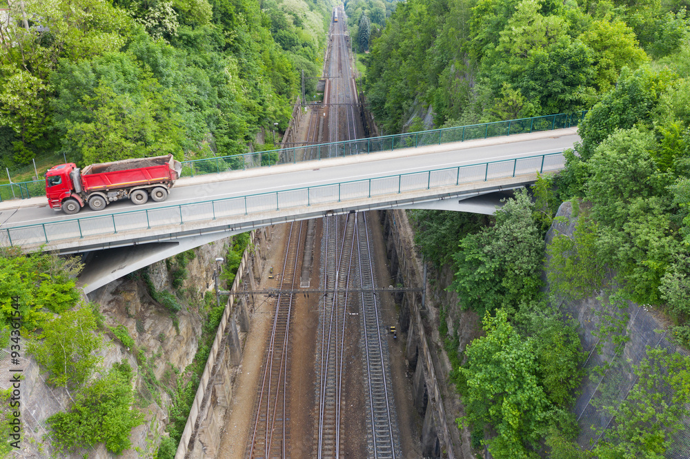 Aerial view shot by a drone of a road bridge over the railroad tracks. High quality photo. New road bridge over old railway. Summer day viaduct over the railway. Aerial view shot by a drone of a road bridge over the railroad tracks. High quality photo. New road bridge over old railway. Summer day viaduct over the railway.