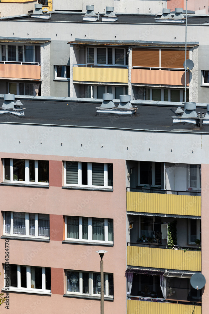 Facades of multi-family residential blocks with balconies. Photo taken on a sunny day.