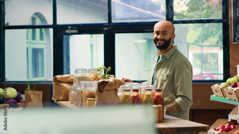 Smiling person looking to buy spices and grains from zero waste eco store, trying to eat healthy food and locally grown produce. Young man buying fresh bio pantry supplies, sustainable lifestyle. Smiling person looking to buy spices and grains from zero waste eco store, trying to eat healthy food and locally grown produce. Young man buying fresh bio pantry supplies, sustainable lifestyle.
