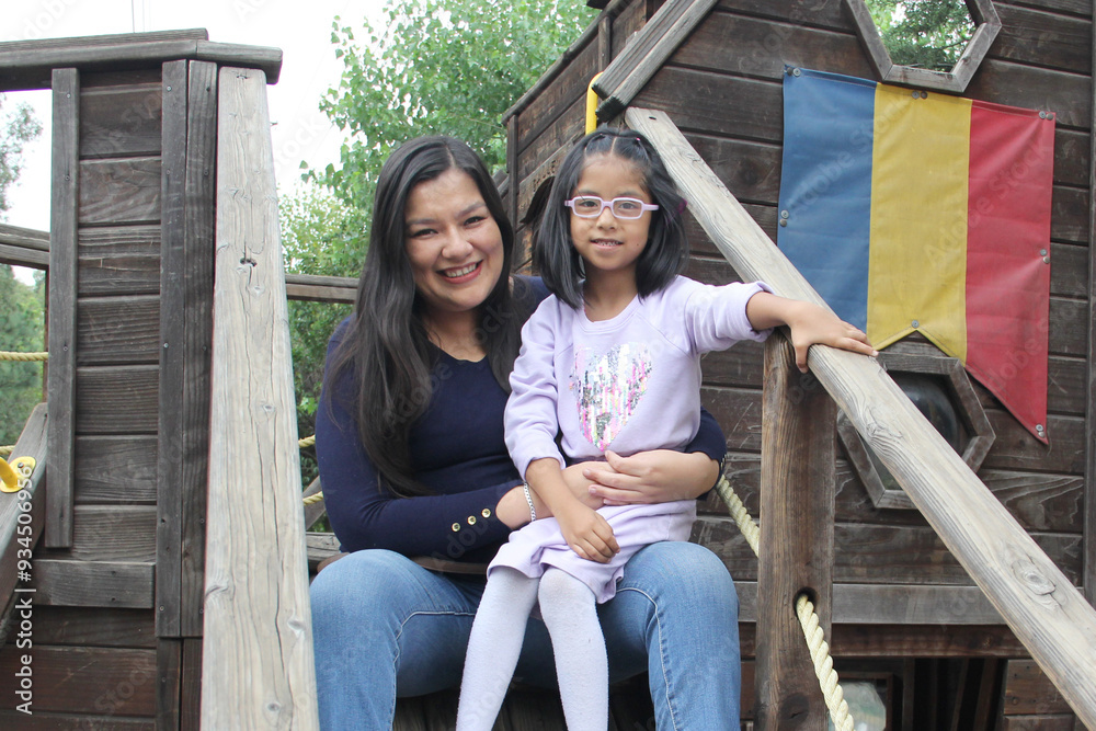 Latina divorced single mom and brunette 5 year old daughter with glasses play in outdoor park games spend quality time together and celebrate Mother's Day Latina divorced single mom and brunette 5 year old daughter with glasses play in outdoor park games spend quality time together and celebrate Mother's Day
