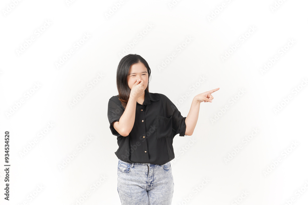 Young Asian woman Smelling something stinky and disgusting wearing Black t-shirt and jeans isolated on white background Young Asian woman Smelling something stinky and disgusting wearing Black t-shirt and jeans isolated on white background