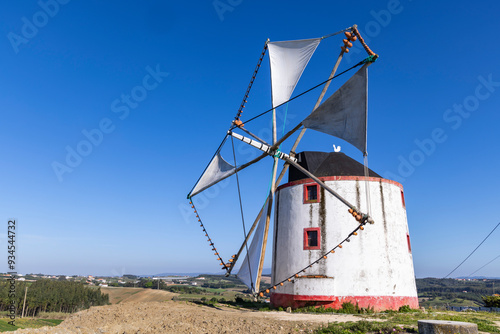 Portugal, Moita dos Ferreiros. Moinhos de Vento. Windmills Traditional Clay pots, jugs, used to catch the winds. Sails billowing. photo