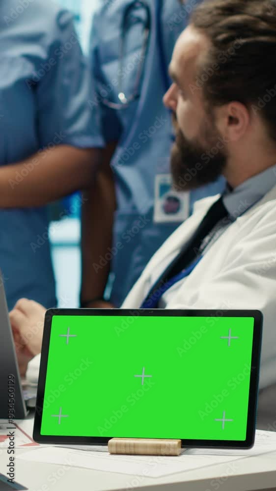 Vertical Video Diverse team of medics analyze x rays next to mockup copy space and discuss treatment plans in a medical office. Healthcare specialists working to provide diagnosis on insurance. Camera Vertical Video Diverse team of medics analyze x rays next to mockup copy space and discuss treatment plans in a medical office. Healthcare specialists working to provide diagnosis on insurance. Camera